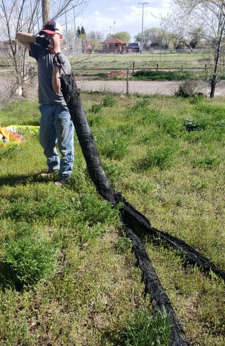 Man-holding-black-roots-on-hook