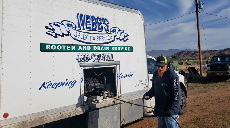 Webb's Select-A-Service employee running a camera down a drain